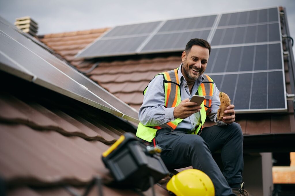 Roofing Profit Splits: 10/50/50 Vs Gross-Based Commission 1 A roofing sales rep enjoying a croissant on a roof while pondering roofing profit splits: 10/50/50 vs gross-based commission