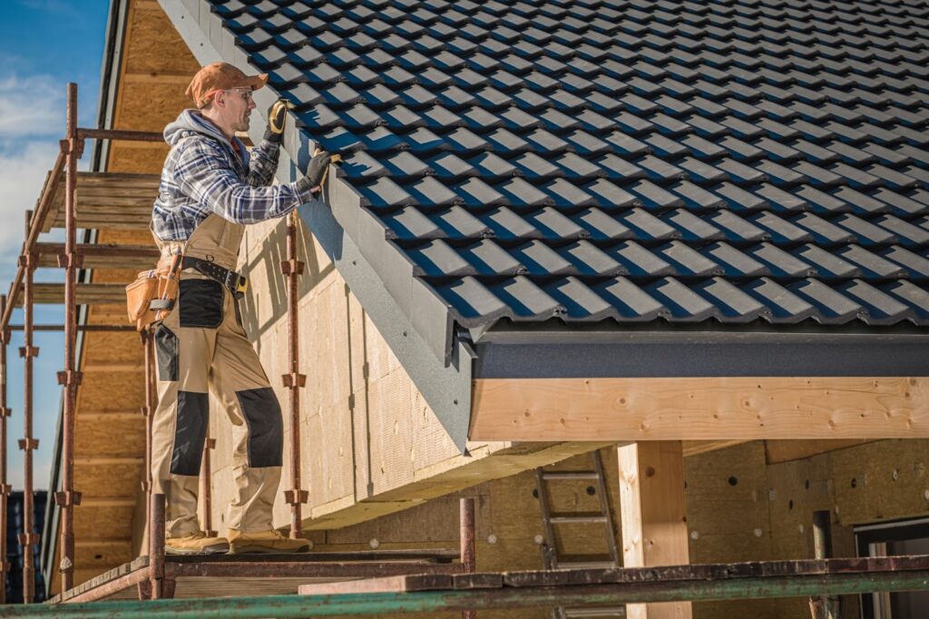 A man repairing a roof, no doubt after learning why roofing business cards fail (and how to fix them fast)